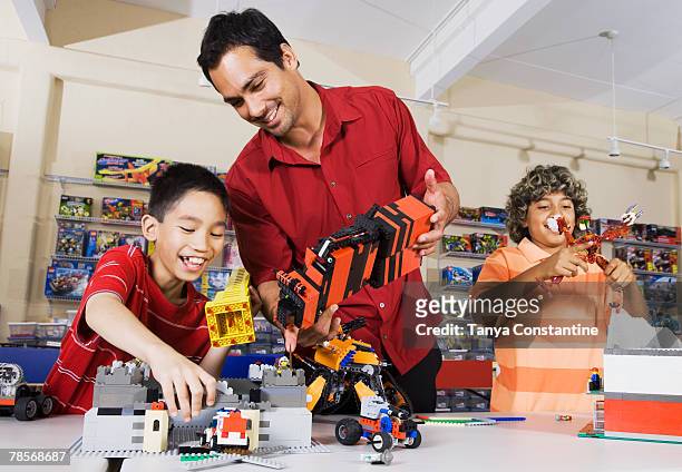 multi-ethnic children playing at toy store - toy store stock pictures, royalty-free photos & images