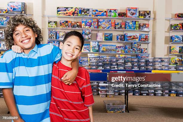 multi-ethnic boys hugging - philippines friends stock pictures, royalty-free photos & images