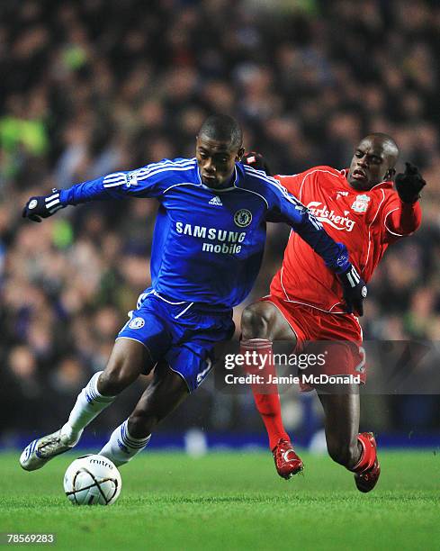 Salomon Kalou of Chelsea holds off the challenge of Momo Sissoko of Liverpool during the Carling Cup Quarter Final match between Chelsea and...