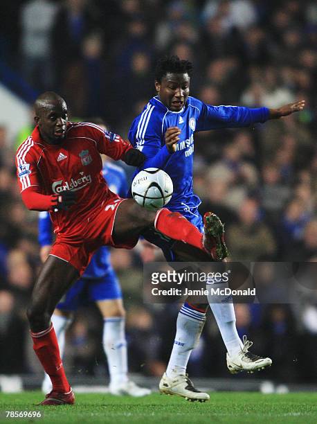 John Obi Mikel of Chelsea challenges Momo Sissoko of Liverpool during the Carling Cup Quarter Final match between Chelsea and Liverpool at Stamford...