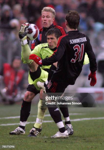 Christian Lell and Bastian Schweinsteiger of Bayern in action with Garcia Ronald of Saloniki during the UEFA Cup Group F match between Bayern Munich...