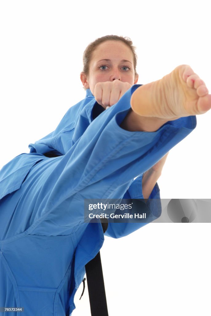 Martial artist executing a roundhouse kick.