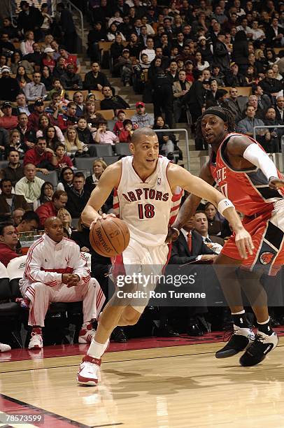 Anthony Parker of the Toronto Raptors moves the ball against Jeff McInnis of the Charlotte Bobcats during the game on December 3, 2007 at the Air...