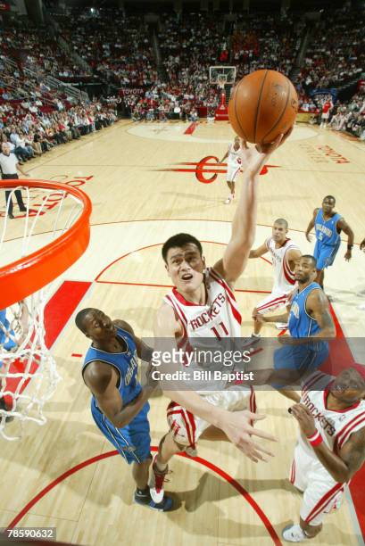 Yao Ming of the Houston Rockets shoots the ball over Maurice Evans of the Orlando Magic at the Toyota Center December 19, 2007 in Houston, Texas....