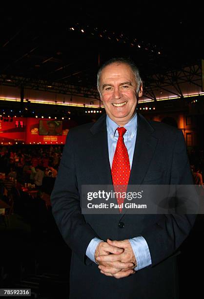 Commentator Sid Waddell poses following the the first round match between Phil Taylor of England and Michael van Gerwen of Netherlands during the...