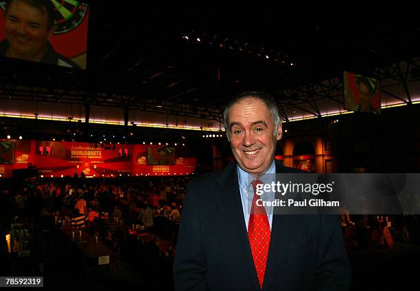 Commentator Sid Waddell poses following the the first round match between Phil Taylor of England and Michael van Gerwen of Netherlands during the...