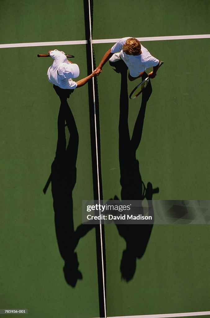 Tennis, men shaking hands over net