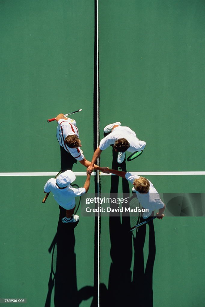 Tennis, doubles players shaking hands over net, overhead view