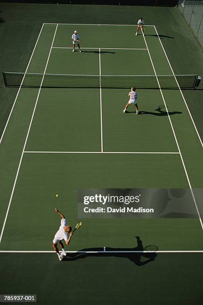 tennis, men playing doubles on green court, elevated view - doubles tennis stock-fotos und bilder