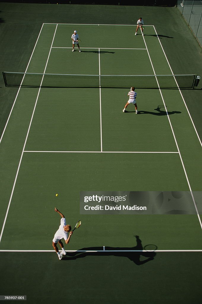 Tennis, men playing doubles on green court, elevated view