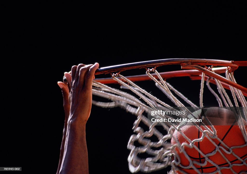 Basketball, ball being dunked through basket, close up