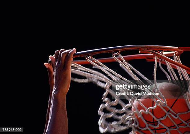 basketball, ball being dunked through basket, close up - basketball stockfoto's en -beelden