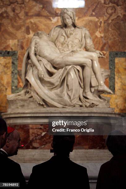 French President Nicolas Sarkozy stops to view the marble statue The 'Pieta', by Michelangelo, during a visit to St. Peter's Basilica on December 20,...