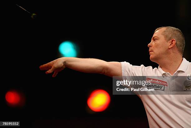 Andy Jenkins of England throws a dart during the first round match between Andy Jenkins of England and Miloslav Navratil of Czech Republic during the...