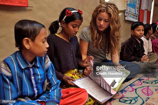 In this handout from United Nations Children's Fund , Shakira, an UNICEF ambassador, sits with children at a Bangladesh Rural Advancement Committee...
