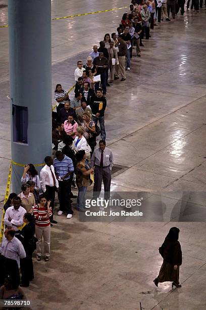 People line up to be seated as new American citizens during the naturalization ceremony conducted by the Immigration and Naturalization Service at...