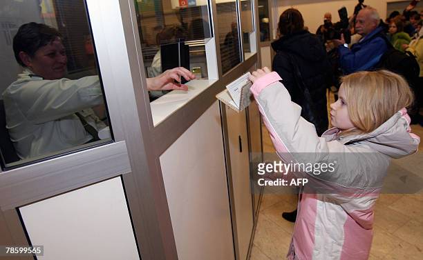 Girl holds up a passport 20 december 2007 at the airport in Tallin minutes before proceedings marked the entry of Estonia into the Schengen...