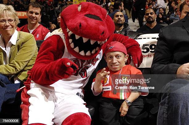 The Raptor poses with Verne Troyer, aka Mini-Me, as the Toronto Raptors play against the Memphis Grizzlies during the game on November 28, 2007 at...