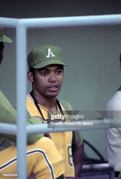 Outfielder Reggie Jackson of the Oakland Athletics watches from the dugout during a circa 1960s Major League Baseball game. Jackson played for the...