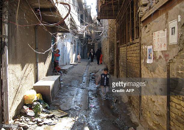 An Iraqi boy walks down an alley of Baghdad's central Fadel area, 18 December 2007. In Fadel, a Sunni Muslim working-class quarter in central...