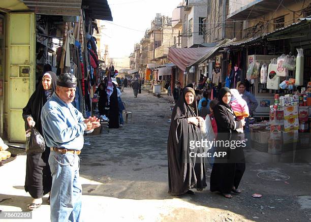 Iraqis shop at a street in Baghdad's central Fadel area, 18 December 2007. In Fadel, a Sunni Muslim working-class quarter in central Baghdad,...