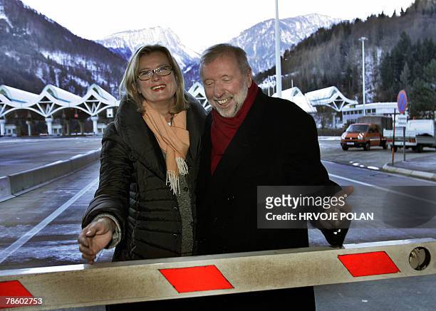 Austrian Foreign Minister Ursula Plassnik and her Slovenian counterpart Dmitrij Rupel prepare to open a barrier at Karavanke tunnel checkpoint...