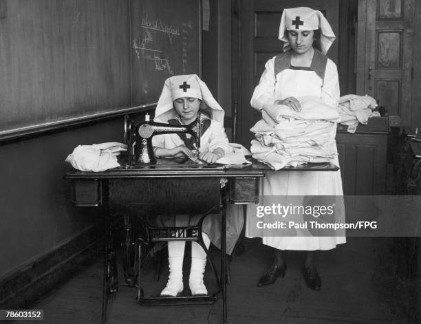 Girls from the East Side in New York sew clothing for children orphaned in France and Belgium by World War I, circa 1918.