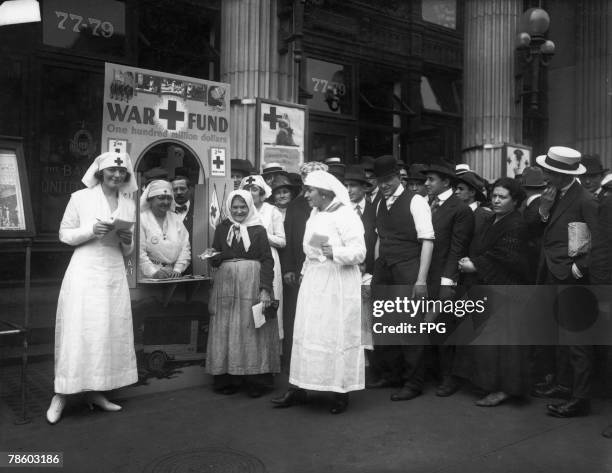 An American Red Cross War Fund office in front of a bank on Delancey Street, circa 1918.