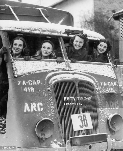 American Red Cross Clubmobile girls in a captured German vehicle in France during World War II. Circa 1942. They are serving with the 36th Infantry...