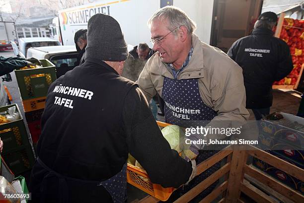 Members of charitable society Muenchner Tafel organize food for a soup kitchen at Central Fruit Market on December 21, 2007 in Munich, Germany. The...