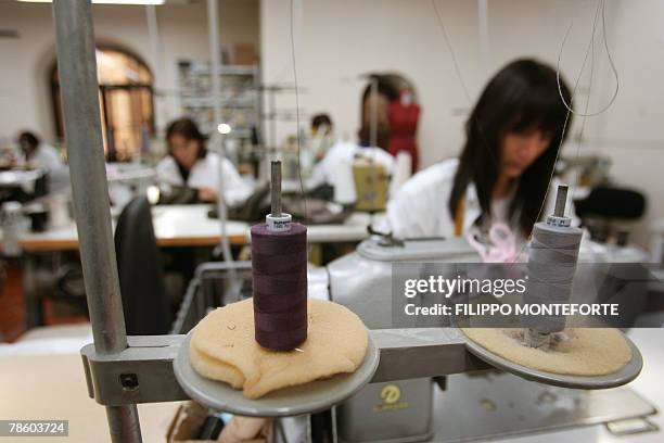 Dressmakers sew cachemere pieces, 14 December 2007, in Italian luxury designer Brunello Cucinelli factory in the medieval hilltop village of Solomeo....