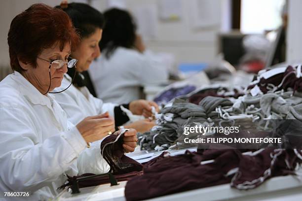 Dressmakers sew cachemere pieces, 14 December 2007, in Italian luxury designer Brunello Cucinelli factory in the medieval hilltop village of Solomeo....