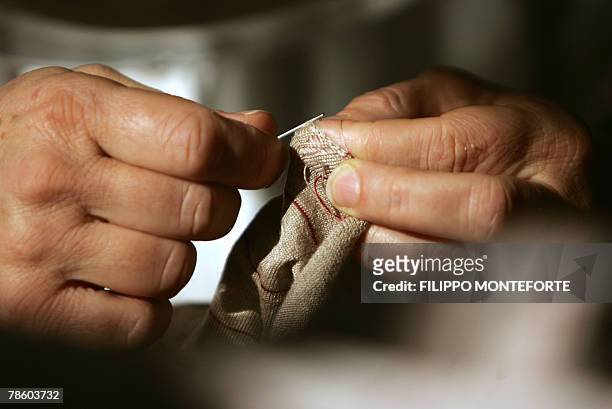 Dressmaker sews a cachemere knitwear, 14 December 2007, in Italian luxury designer Brunello Cucinelli factory in the medieval hilltop village of...