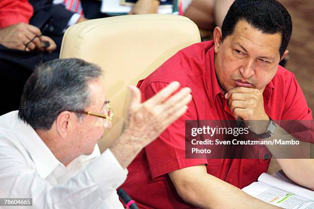 Acting President of Cuba Raul Castro gives a speech as President of Venezuela Hugo Chavez listens during the opening session of the 4th PetroCaribe...