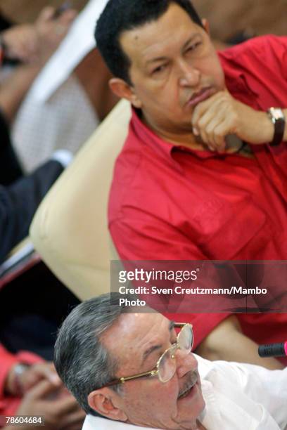 Acting President of Cuba Raul Castro gives a speech as President of Venezuela Hugo Chavez listens during the opening session of the 4th PetroCaribe...