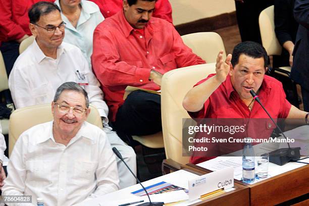 Acting President of Cuba Raul Castro and President of Venezuela Hugo Chavez laugh as they kindly ask the press to leave during the opening session of...