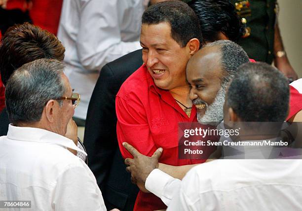 President of Venezuela Hugo Chavez hugs President of Haiti Rene Preval , as they laugh with acting President of Cuba Raul Castro during the opening...