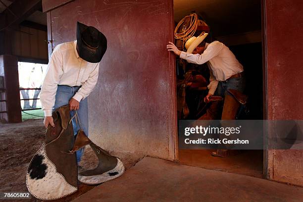 Guthrie Jaguar six man football players Ty Fox and Clint Morgan prepare to work their horses on the 6666 Ranch October 24, 2007 in Guthrie, Texas....