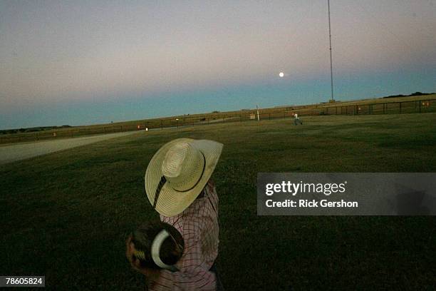 Guthrie Jaguar six man football player Ty Fox throws the ball with his younger brother before dinner on the 6666 Ranch October 25, 2007 in Guthrie,...