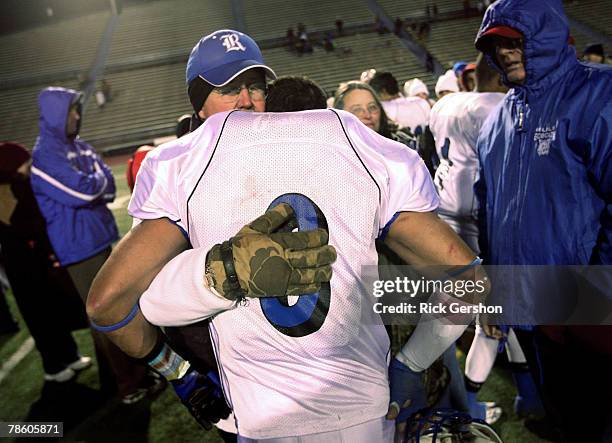 Rule Bobcat Stephen Pace is comforted after losing the Division I six-man football state championship to the Richland Springs Coyotes on December 15...