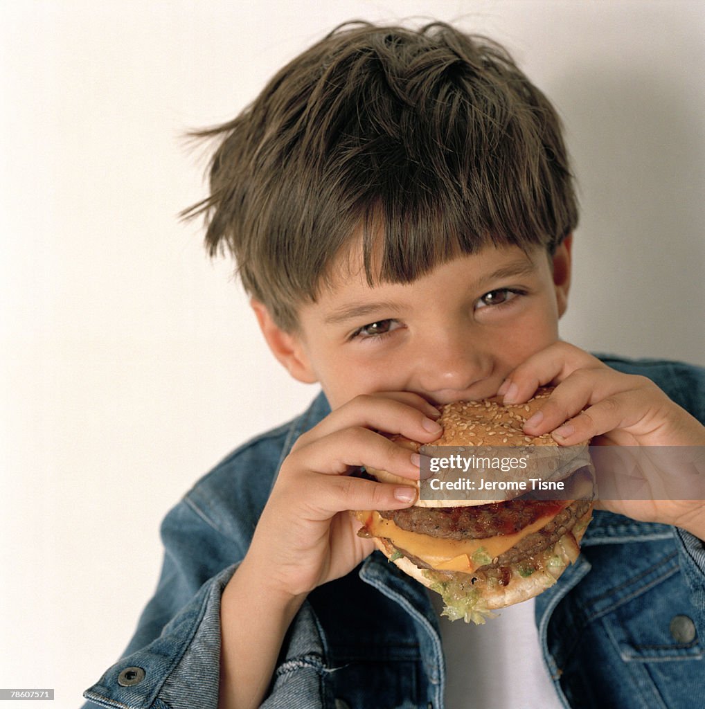 Boy eating hamburger