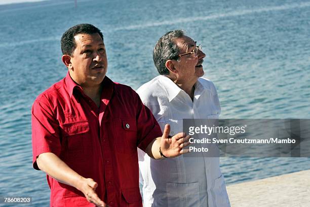 President of Venezuela Hugo Chavez talks with acting President of Cuba Raul Castro during the formal group photo session during the 4th PetroCaribe...