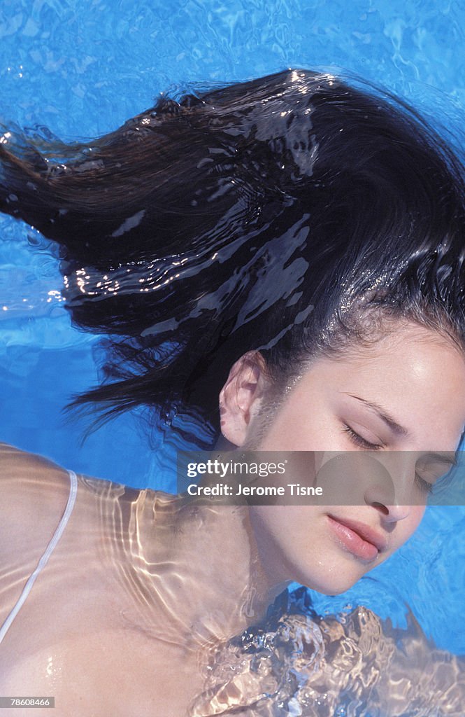 Woman Floating In Pool Woman Floating In Swimming Pool High-Res Stock Photo - Getty Images