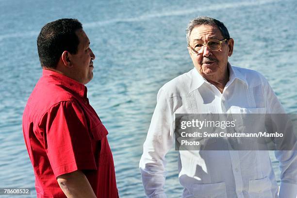 President of Venezuela Hugo Chavez talks with acting President of Cuba Raul Castro during the formal group photo session during the 4th PetroCaribe...