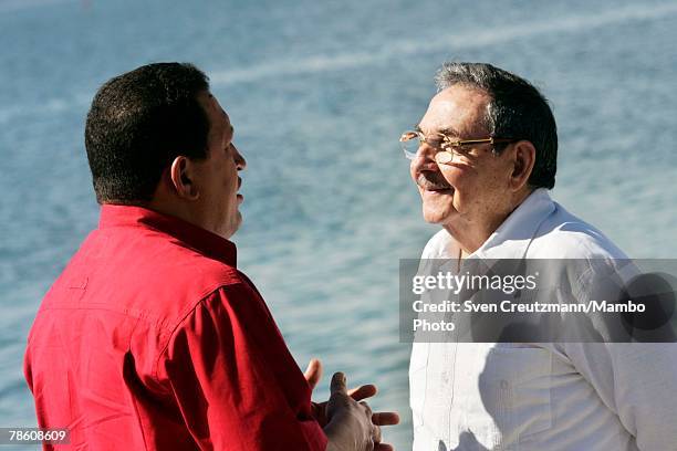 President of Venezuela Hugo Chavez talks with acting President of Cuba Raul Castro during the formal group photo session during the 4th PetroCaribe...