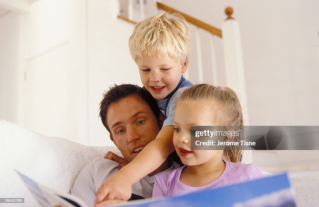 Father reading with children