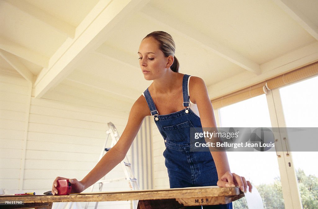 Woman measuring wallpaper