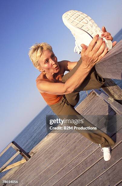 woman stretching at boardwalk - bridge of sigh stock pictures, royalty-free photos & images