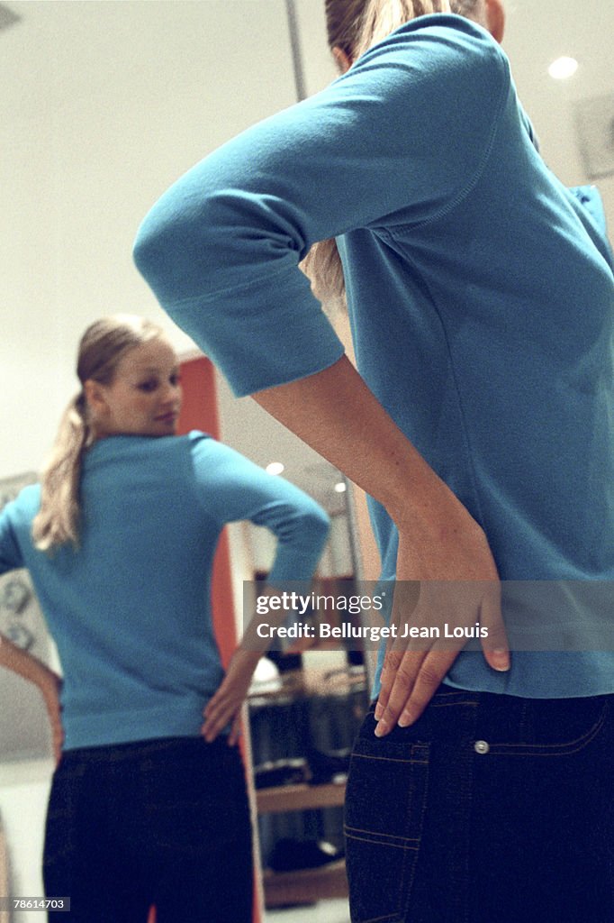 Woman trying on clothing in store