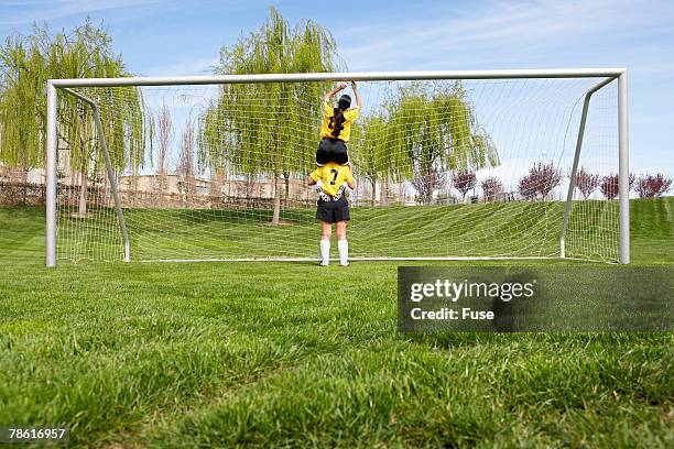 soccer players repairing the net - soccer goal stock pictures, royalty-free photos & images